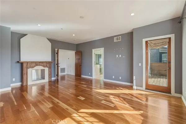a view of a livingroom with wooden floor and a window
