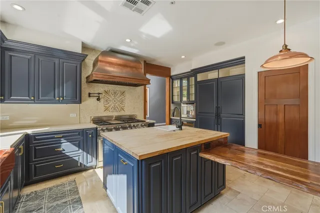 a kitchen with a stove sink and cabinets