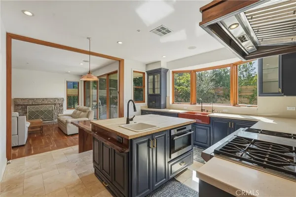 a kitchen with stainless steel appliances granite countertop a sink and a stove