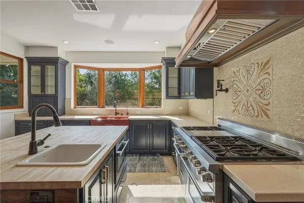 a kitchen that has a sink and a stove