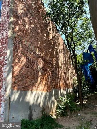 a view of a brick wall with a street