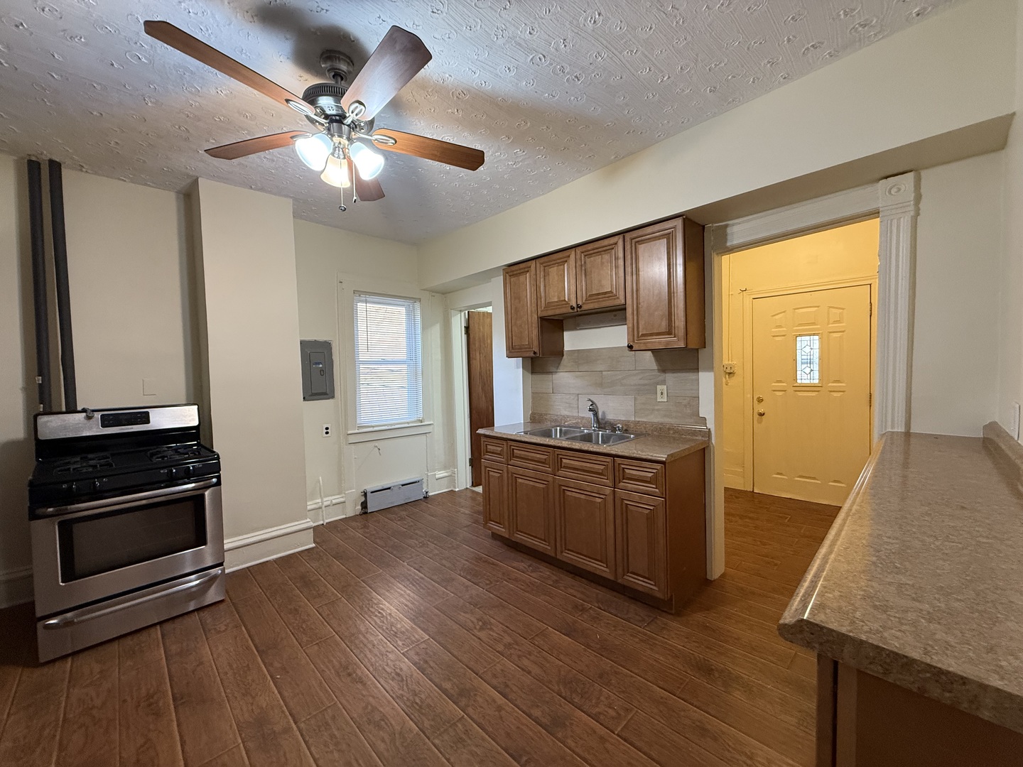 1723 Emerson Street, Unit 1 Evanston, IL 60201 - Photo 11 of 18 a kitchen with granite countertop a refrigerator cabinets and wooden floor