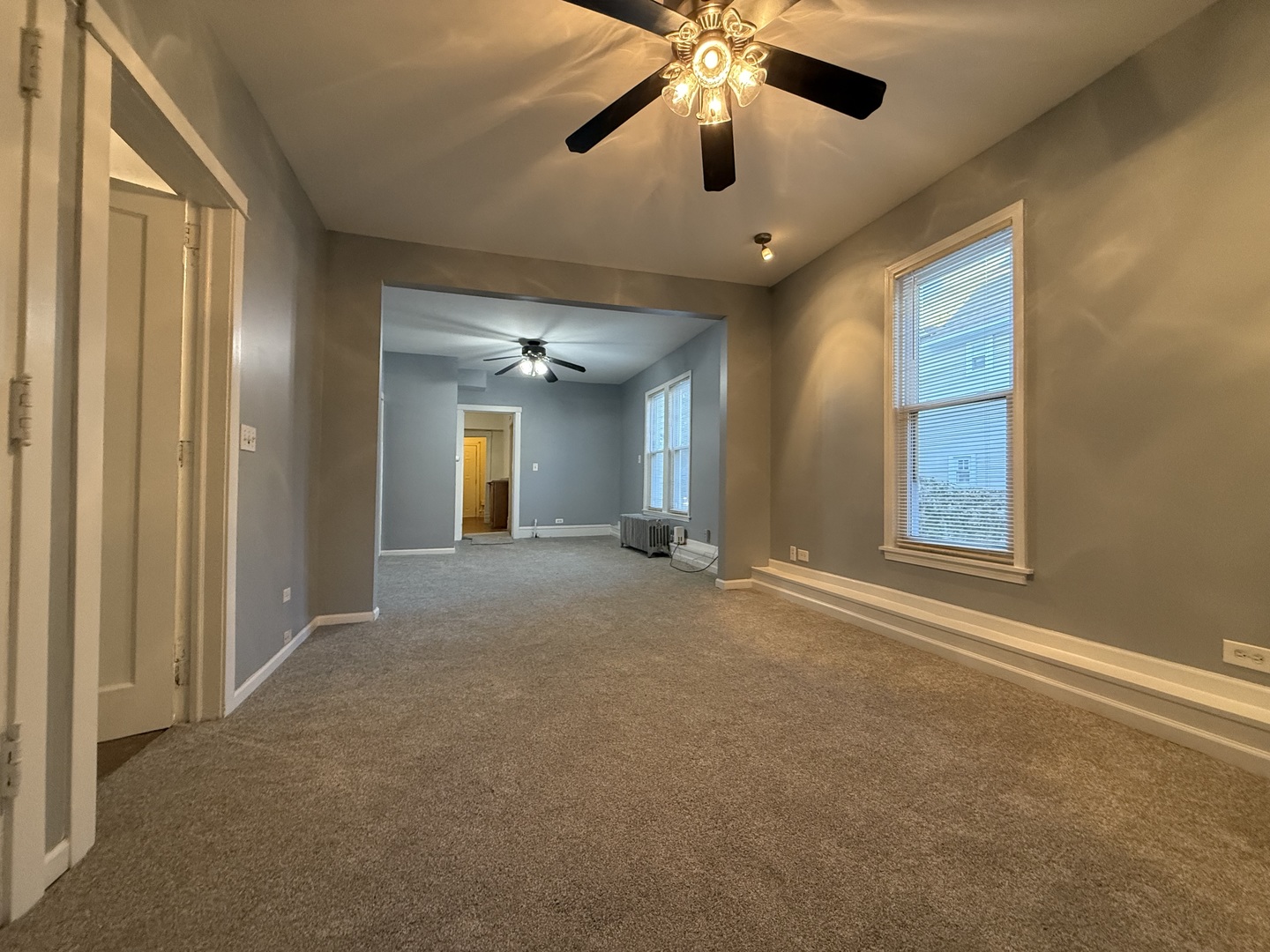 1723 Emerson Street, Unit 1 Evanston, IL 60201 - Photo 17 of 18 an empty room with chandelier fan and windows