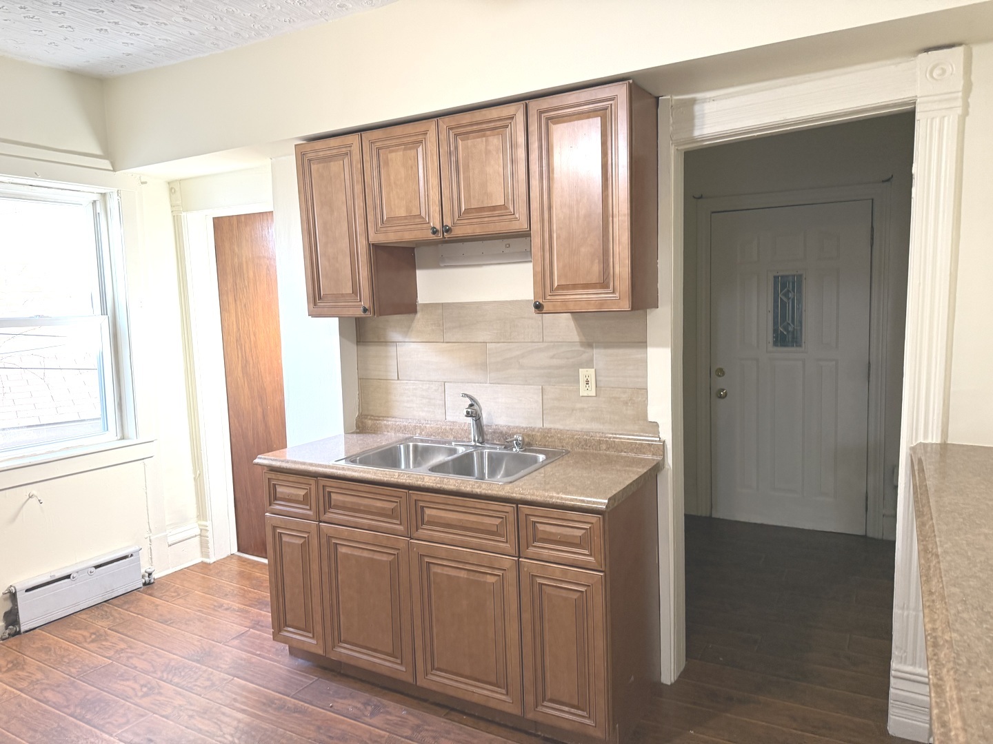 1723 Emerson Street, Unit 1 Evanston, IL 60201 - Photo 3 of 18 a kitchen with a sink a window and cabinets