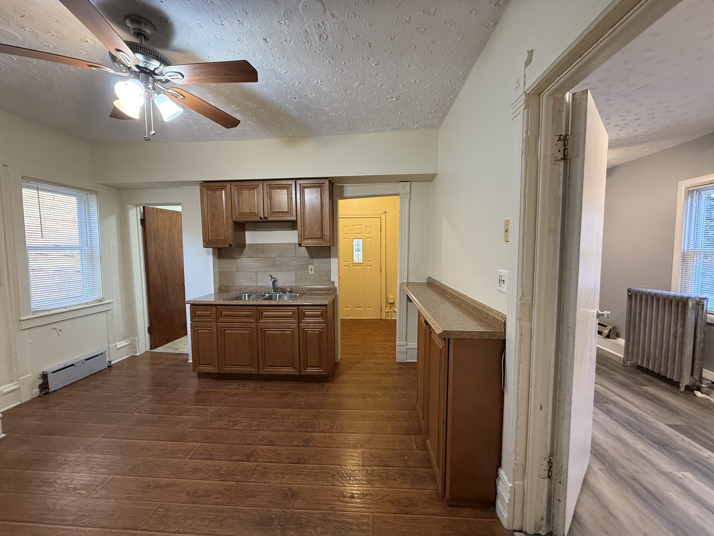 1723 Emerson Street, Unit 1 Evanston, IL 60201 - Photo 4 of 18 a kitchen with granite countertop a refrigerator and a stove top oven
