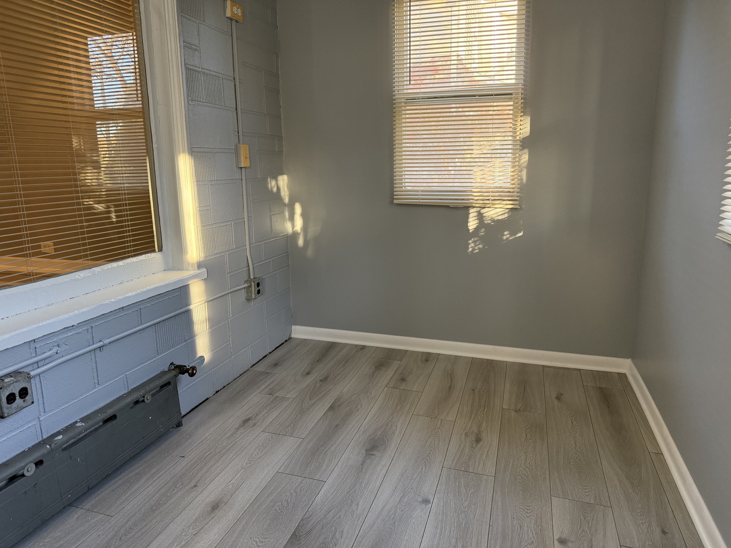1723 Emerson Street, Unit 1 Evanston, IL 60201 - Photo 6 of 18 a view of an empty room with wooden floor and a window