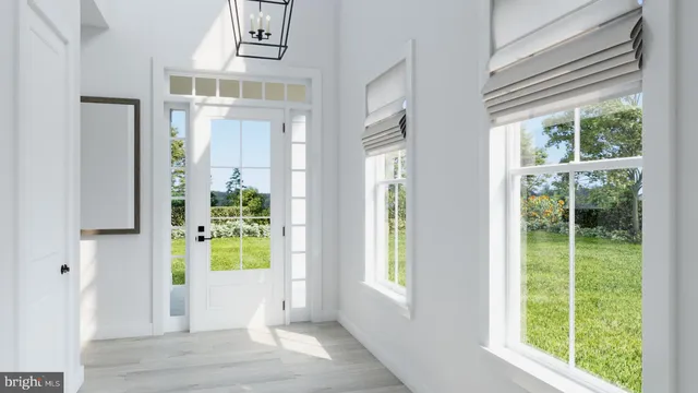 a view of an entryway with wooden floor and a livingroom