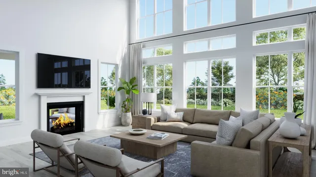 a living room with furniture a fireplace and a large window