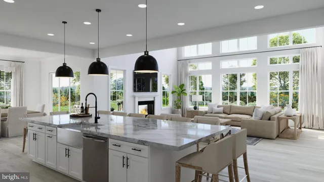 a kitchen with lots of counter space windows and living room