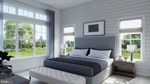 a bedroom with a bed and a large window