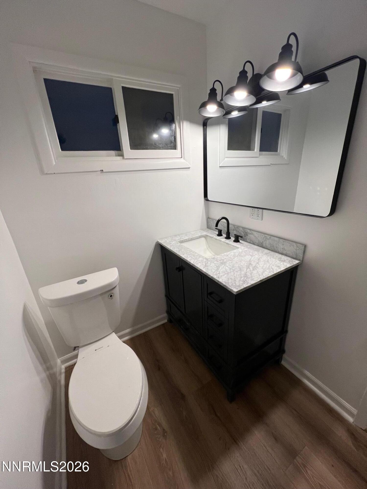 117 West 4th Street Hawthorne, NV 89415 - Photo 16 of 47 a bathroom with a toilet sink and mirror