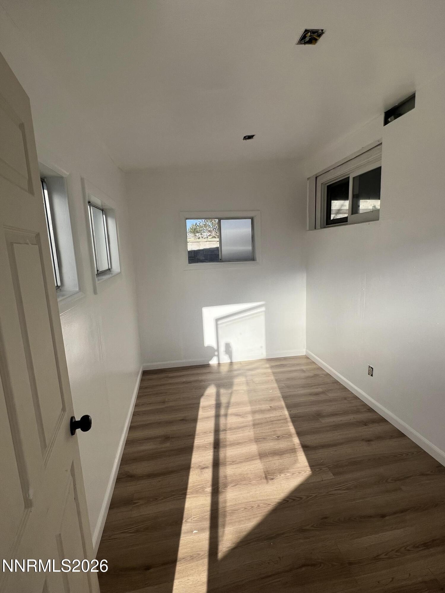 117 West 4th Street Hawthorne, NV 89415 - Photo 25 of 47 a bedroom with a bed and wooden floor