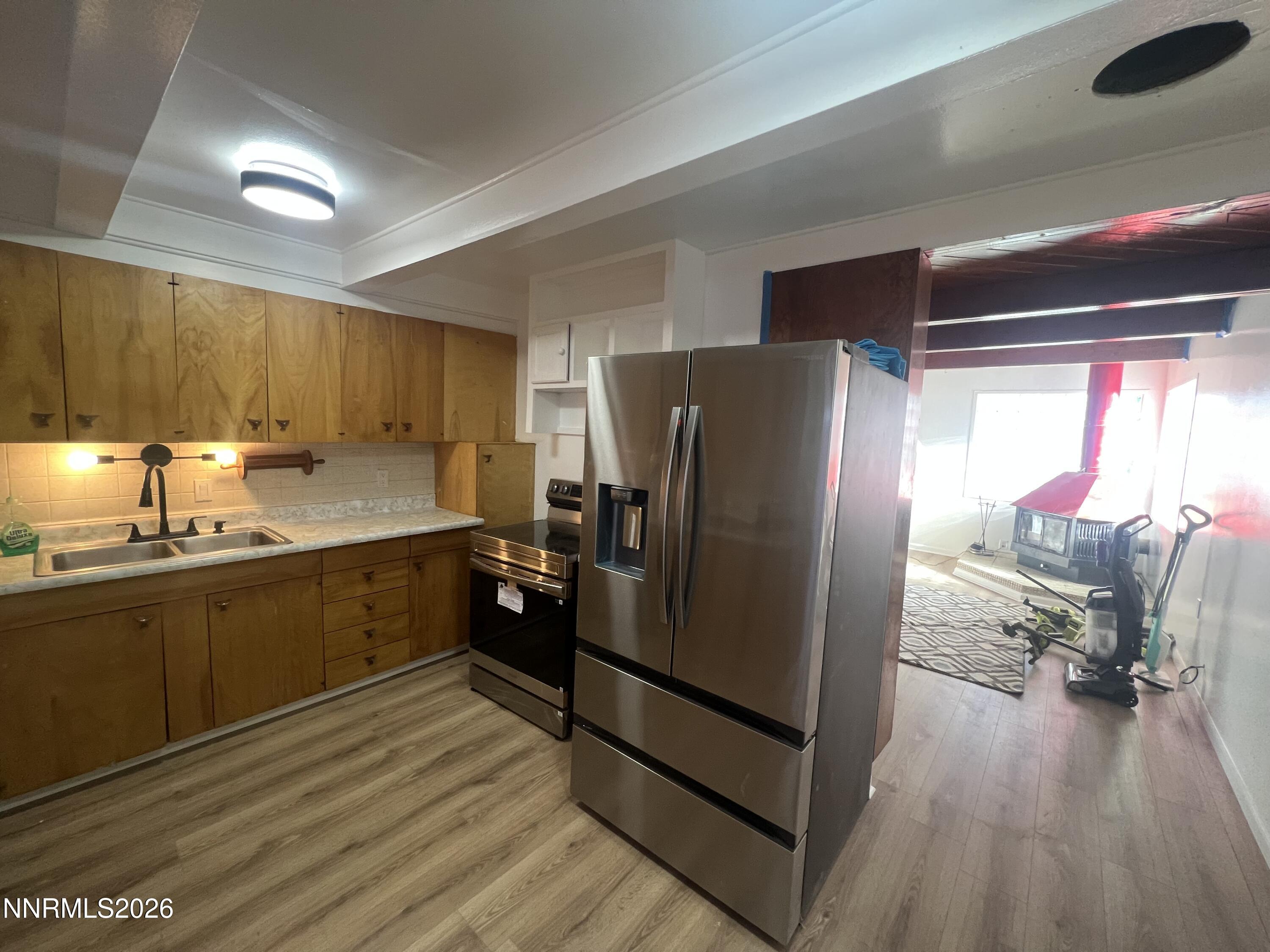 117 West 4th Street Hawthorne, NV 89415 - Photo 5 of 47 a kitchen with granite countertop a refrigerator and a sink