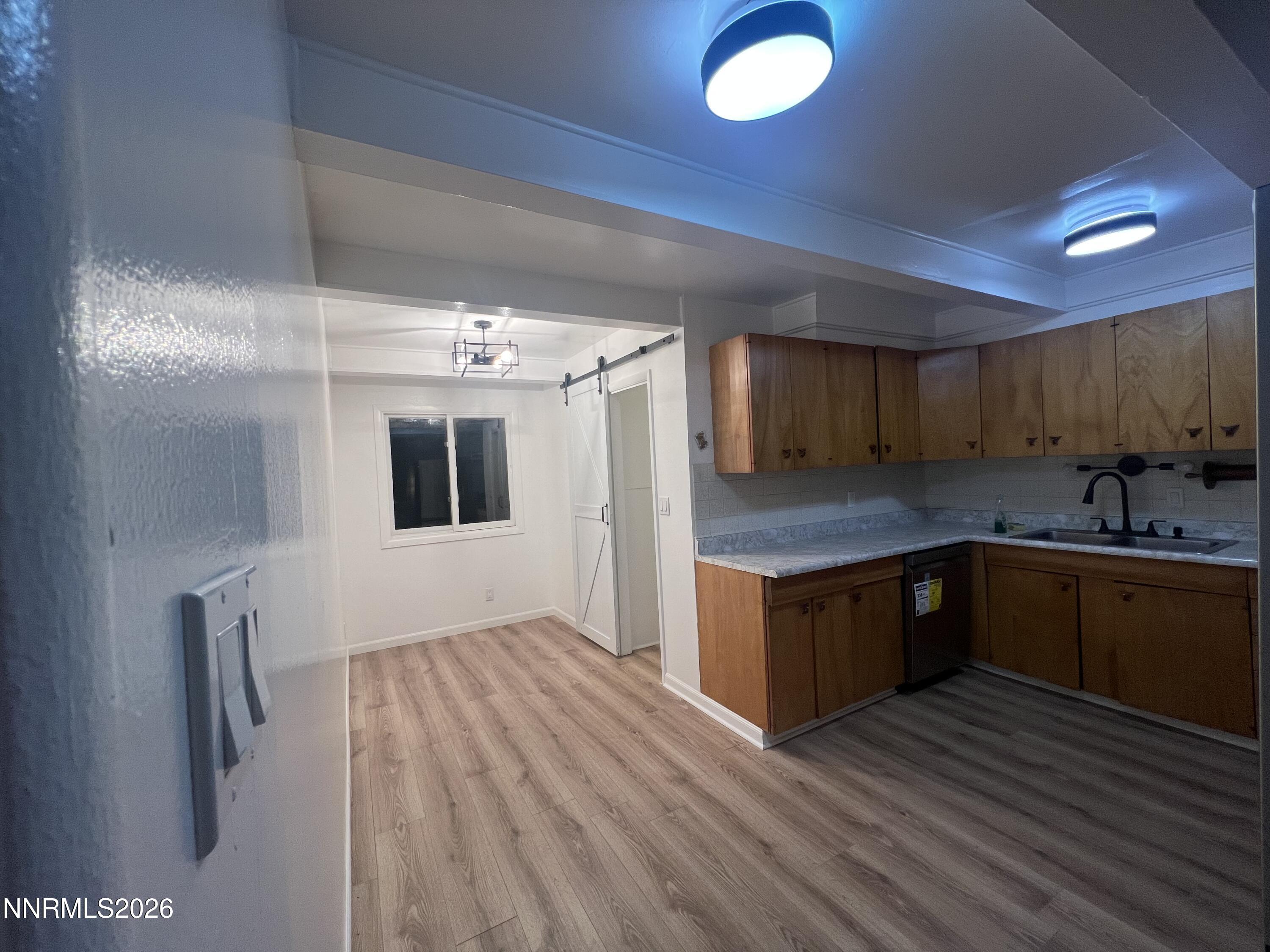 117 West 4th Street Hawthorne, NV 89415 - Photo 9 of 47 a kitchen with granite countertop a sink cabinets and wooden floor