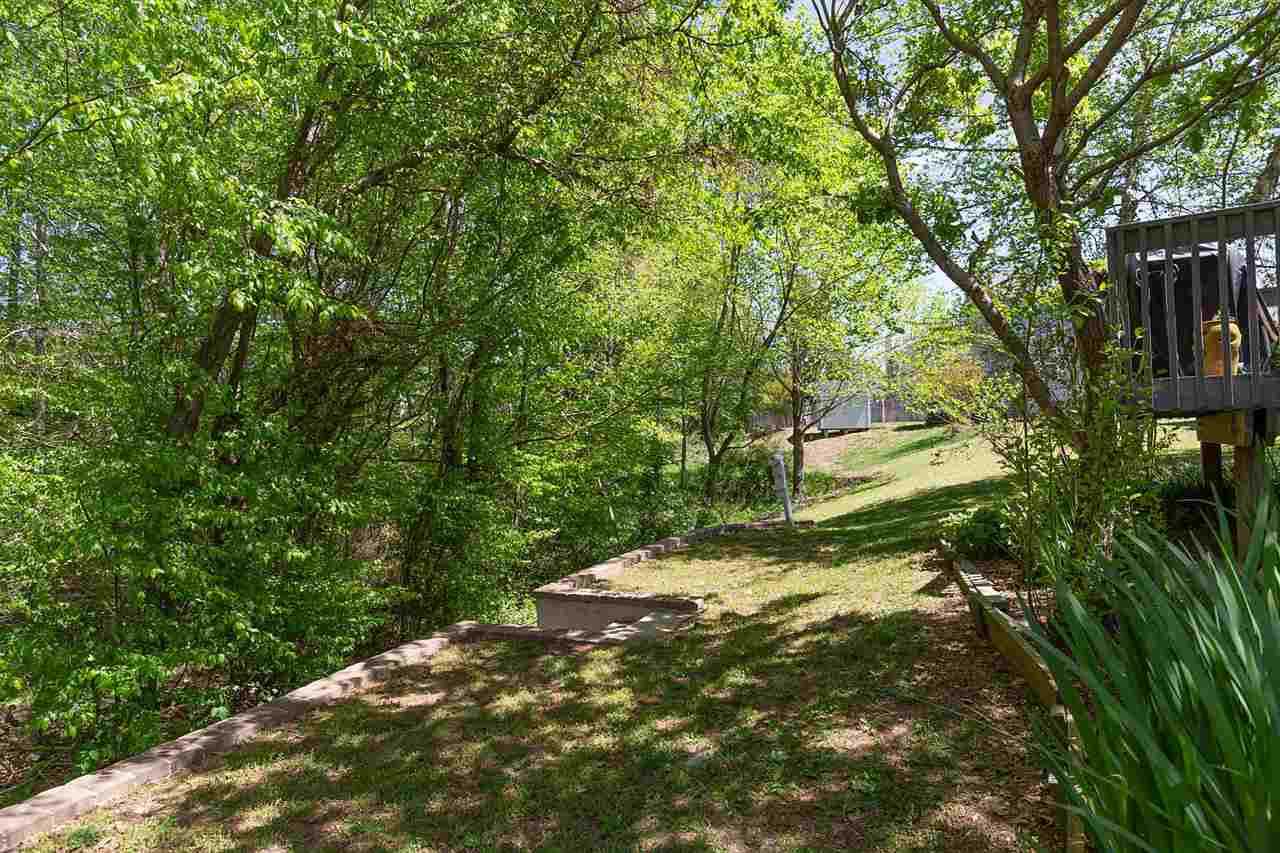 4009 Hopper Street Raleigh, NC 27616 - Photo 21 of 25 Lovely backyard. Mature trees, privacy, and overlooks creek. Exterior Back