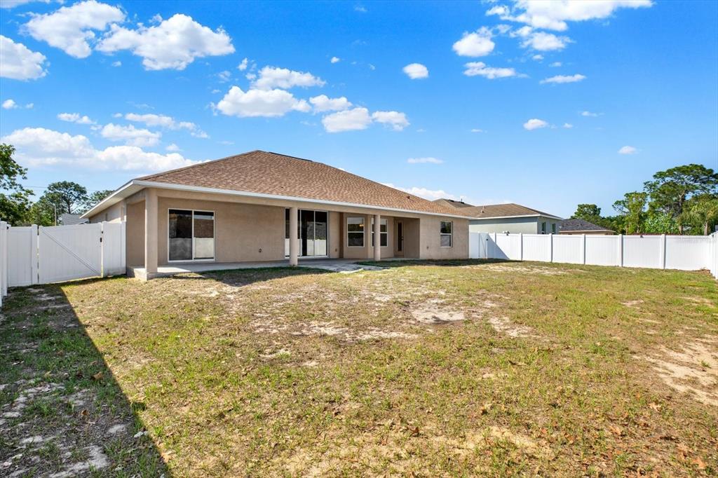 4400 Dior Road Spring Hill, FL 34609 - Photo 32 of 37 a front view of a house with a garden