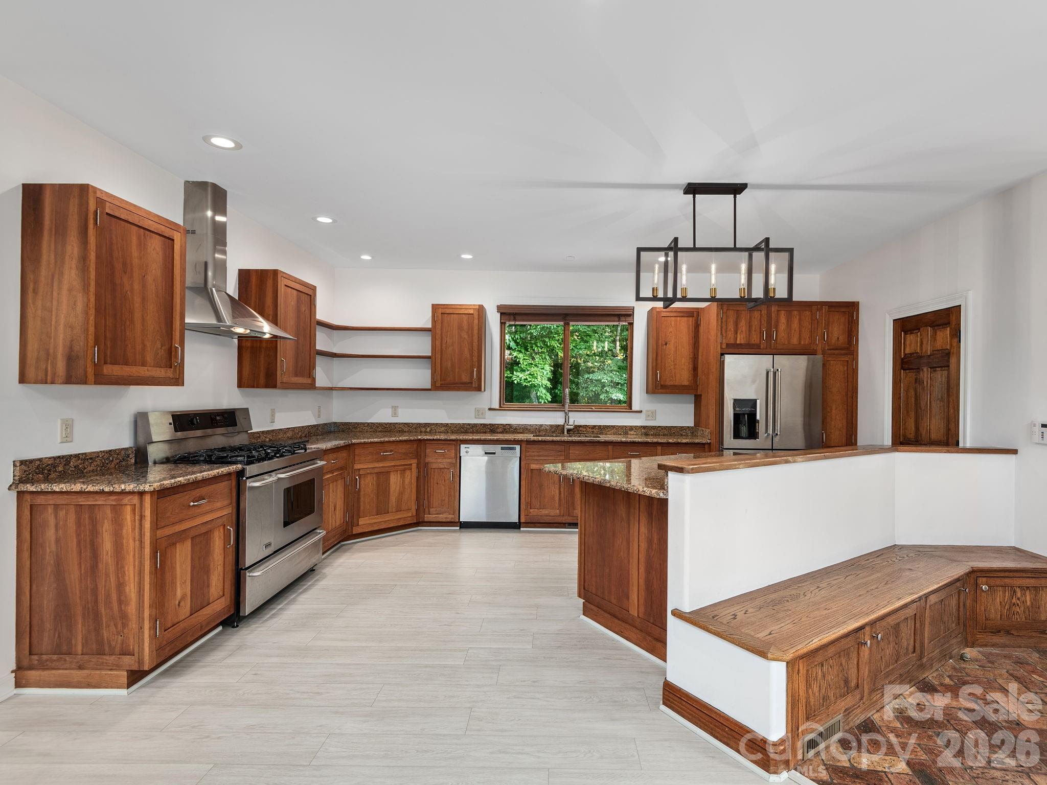 248 Wisdom Cove Road Flat Rock, NC 28731 - Photo 11 of 48 a kitchen with stainless steel appliances granite countertop a stove a sink and a microwave