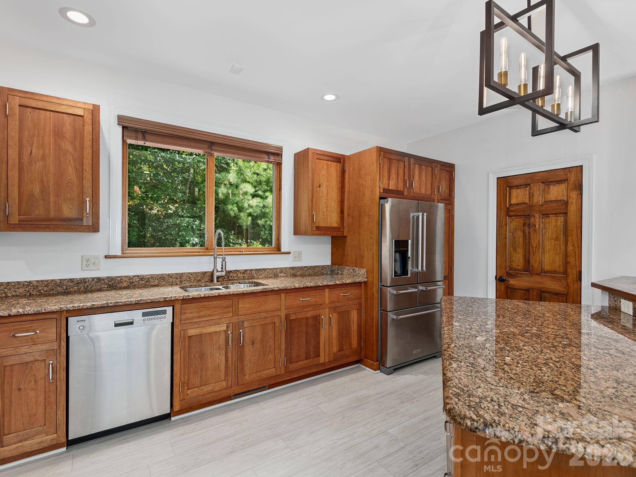 248 Wisdom Cove Road Flat Rock, NC 28731 - Photo 12 of 48 a kitchen with stainless steel appliances granite countertop a refrigerator and a sink