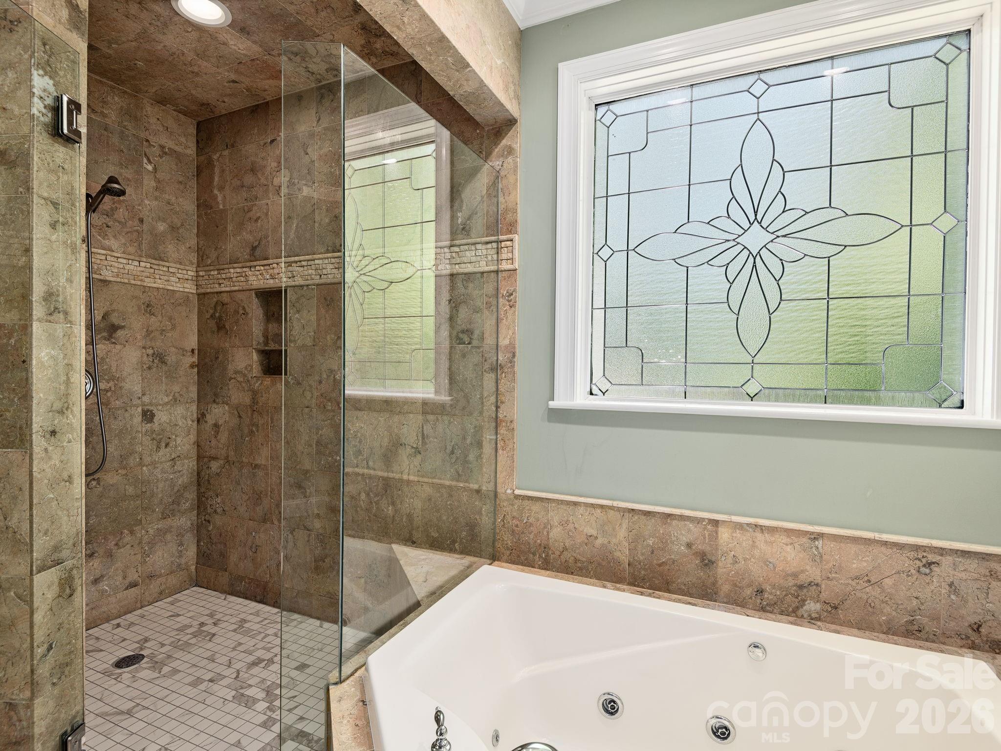 248 Wisdom Cove Road Flat Rock, NC 28731 - Photo 18 of 48 a bathroom with a bathtub and shower