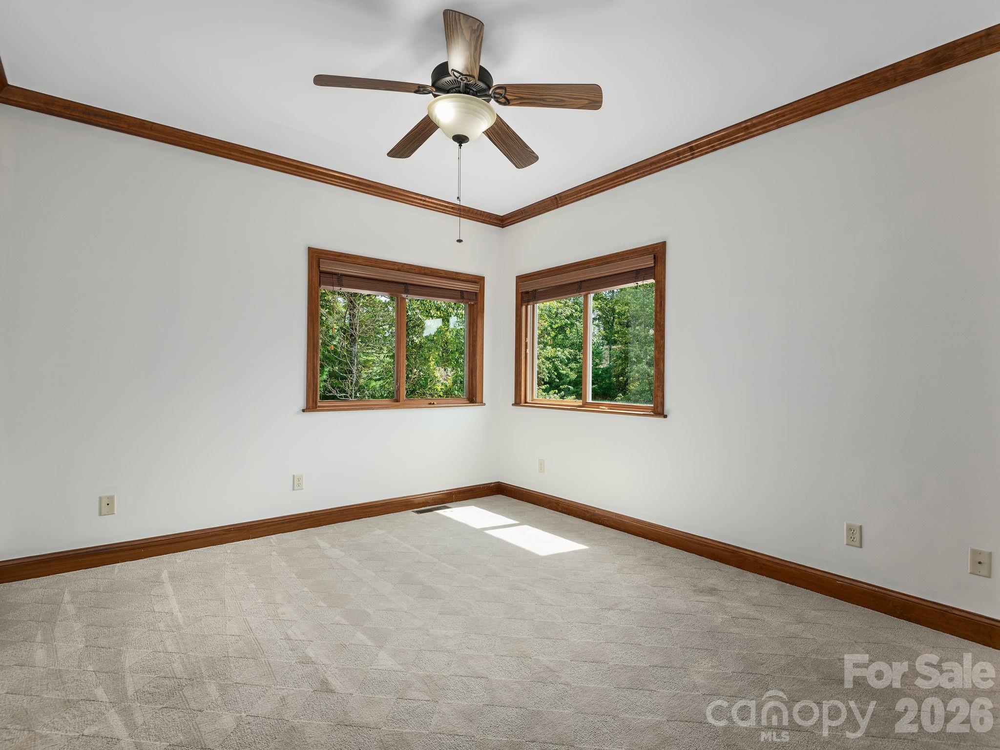 248 Wisdom Cove Road Flat Rock, NC 28731 - Photo 31 of 48 an empty room with windows and ceiling fan