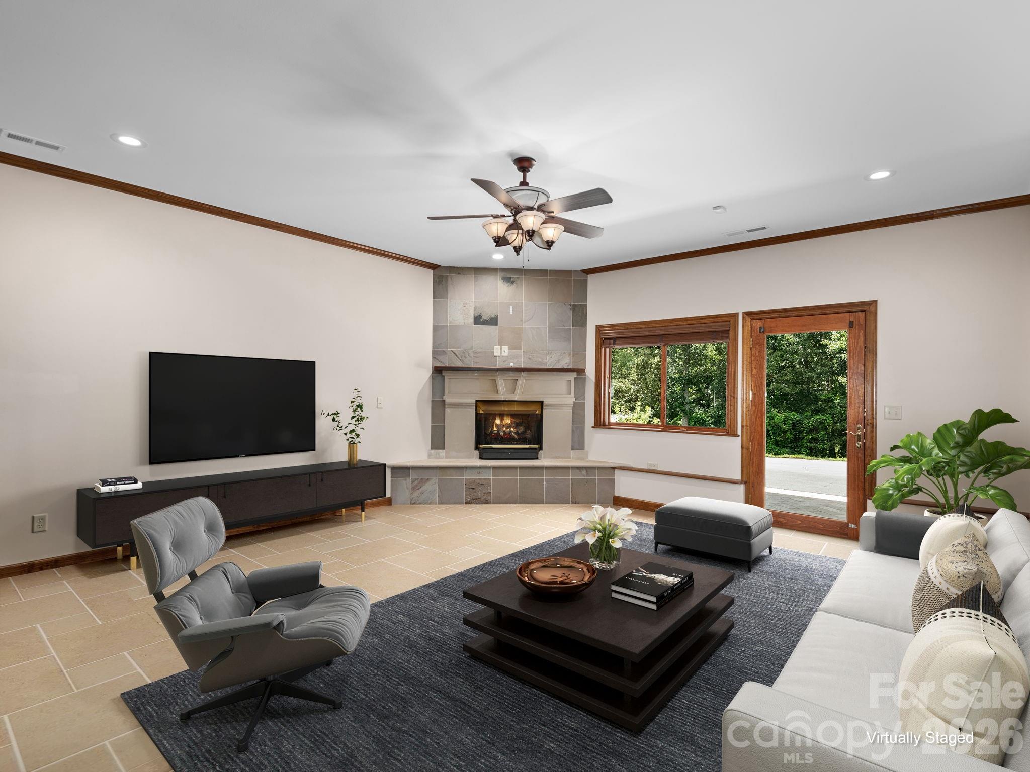 248 Wisdom Cove Road Flat Rock, NC 28731 - Photo 39 of 48 a living room with furniture fireplace and a flat screen tv