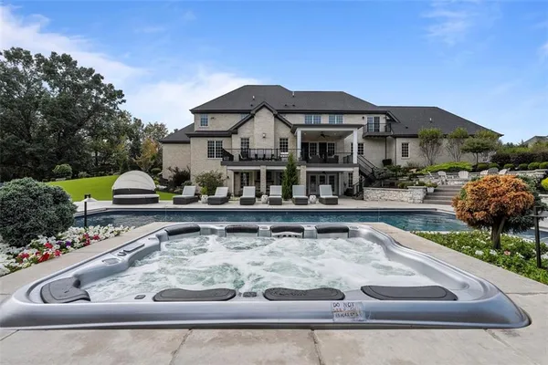 a living room with furniture a fireplace and a floor to ceiling window