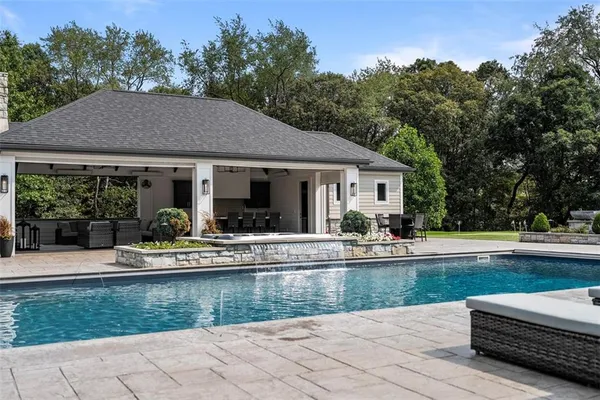 a bathroom with a sink a toilet a mirror and shower