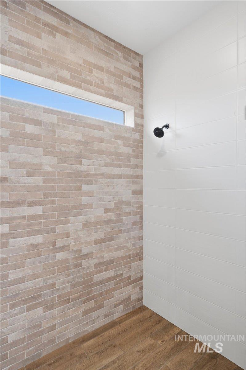 6431 Raptor Ridge Lane Melba, ID 83641 - Photo 32 of 50 Bathroom with wood finished floors and a tile shower