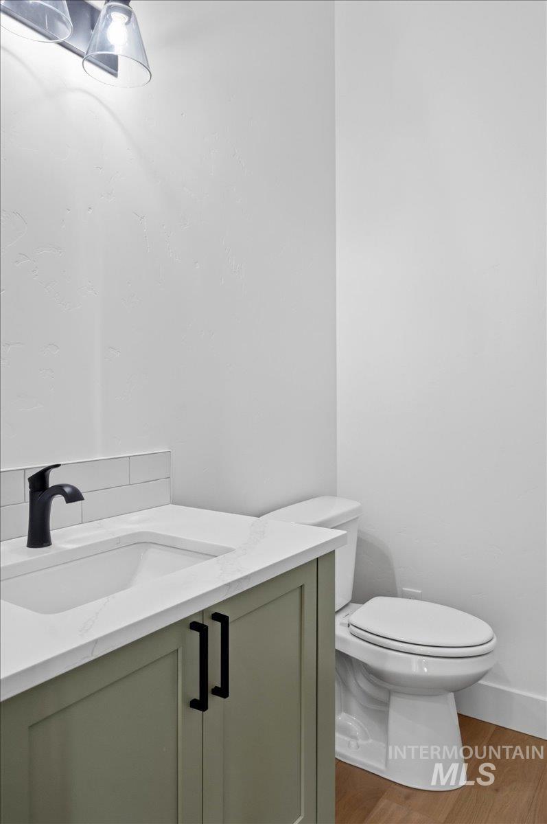 6431 Raptor Ridge Lane Melba, ID 83641 - Photo 39 of 50 Half bath with vanity and light wood-type flooring