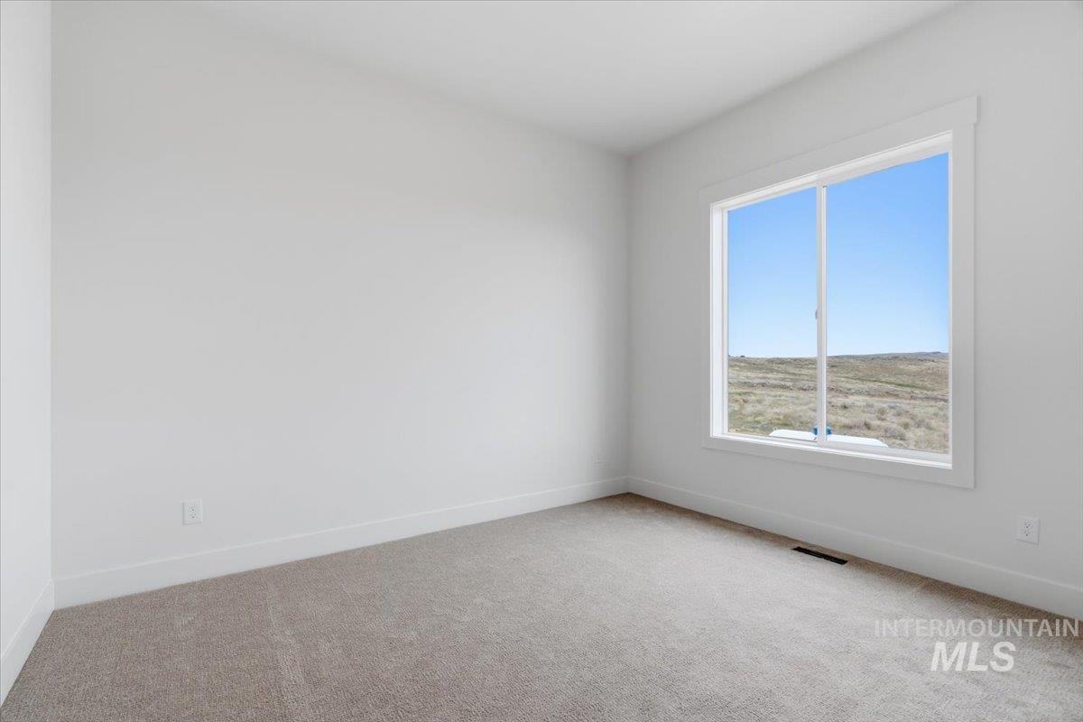 6431 Raptor Ridge Lane Melba, ID 83641 - Photo 41 of 50 Spare room with light colored carpet and baseboards