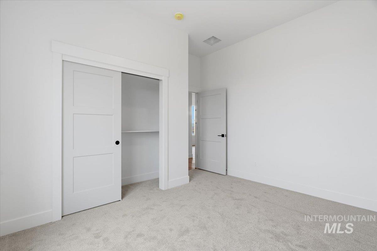 6431 Raptor Ridge Lane Melba, ID 83641 - Photo 42 of 50 Unfurnished bedroom with light carpet and a closet