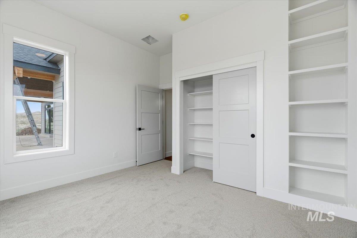 6431 Raptor Ridge Lane Melba, ID 83641 - Photo 45 of 50 Unfurnished bedroom featuring light colored carpet and a closet