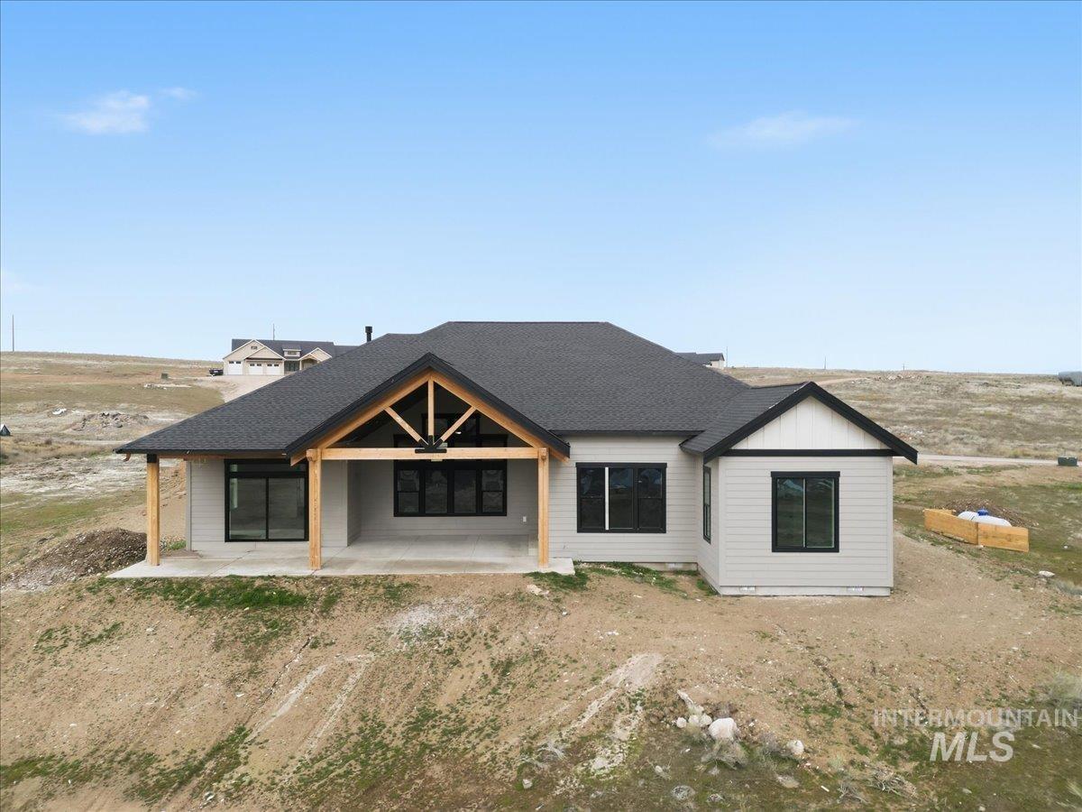 6431 Raptor Ridge Lane Melba, ID 83641 - Photo 6 of 50 Back of property featuring a patio area and roof with shingles