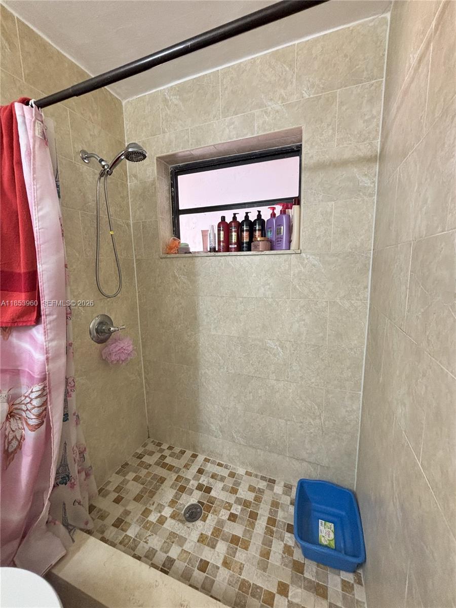 18601 Southwest 98th Avenue Cutler Bay, FL 33157 - Photo 17 of 28 a bathroom with a shower