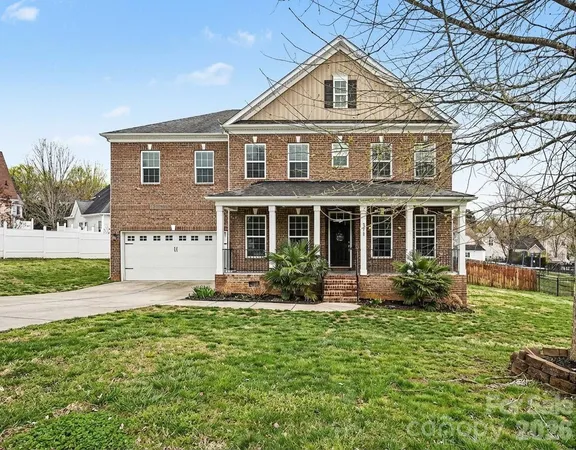 a front view of a house with a yard and outdoor seating