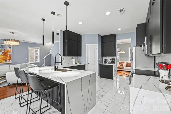 a living room with furniture a flat screen tv and a window