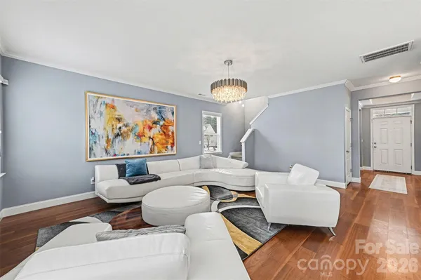 a living room with furniture a large window and a flat screen tv