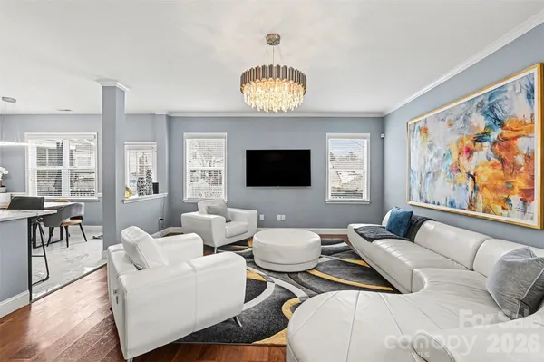 a living room with furniture and a view of kitchen