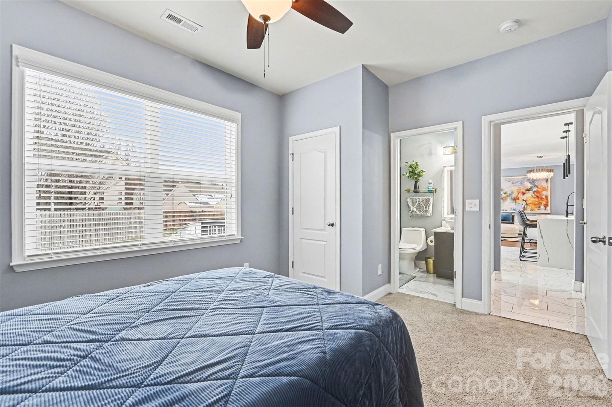 2213 Iron Works Drive Clover, SC 29710 - Photo 17 of 46 a bedroom with a bed and a chandelier