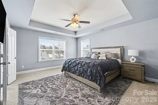 a bedroom with a large bed and a chandelier