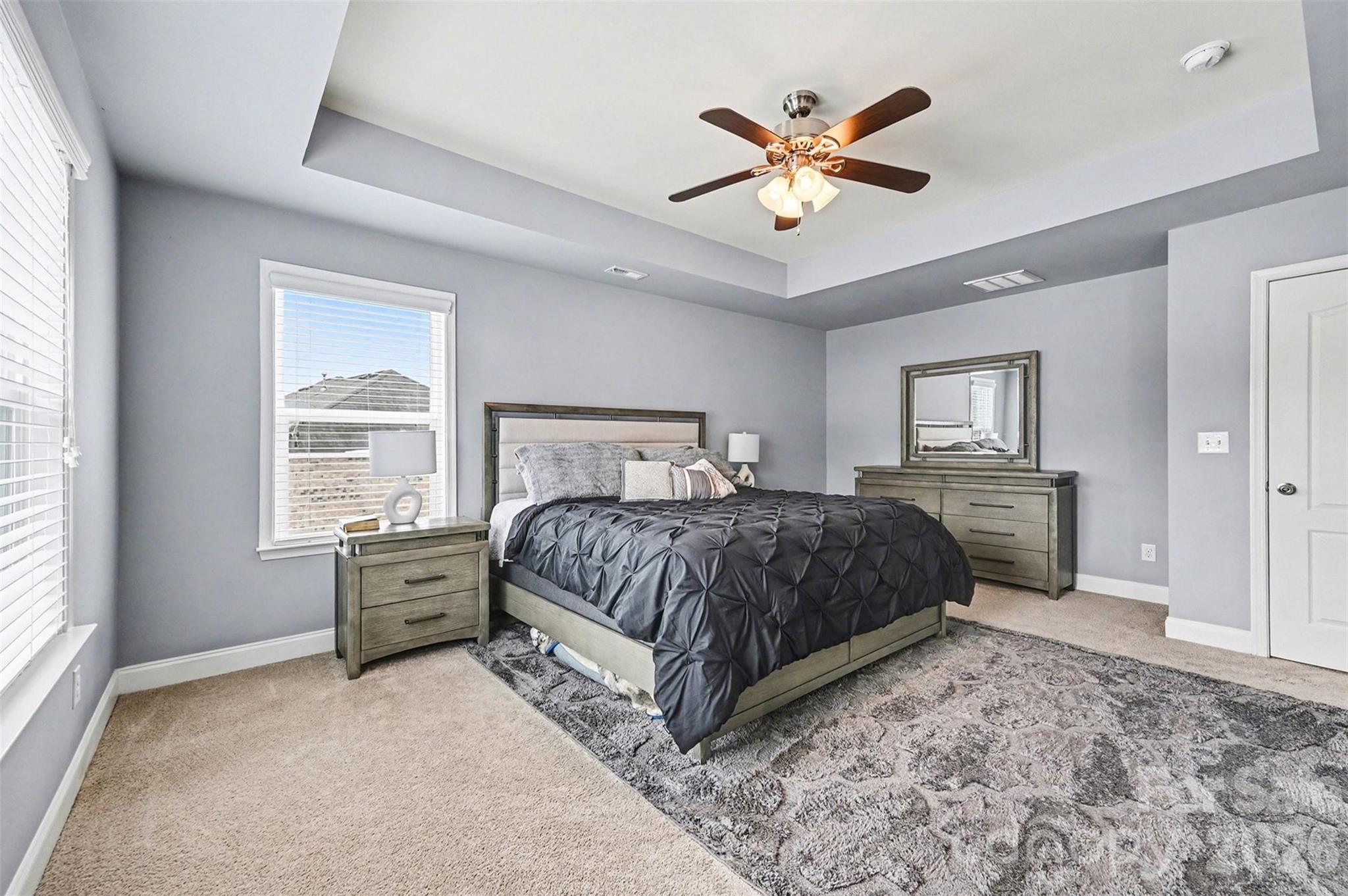 2213 Iron Works Drive Clover, SC 29710 - Photo 23 of 46 a bedroom with a large bed and a chandelier