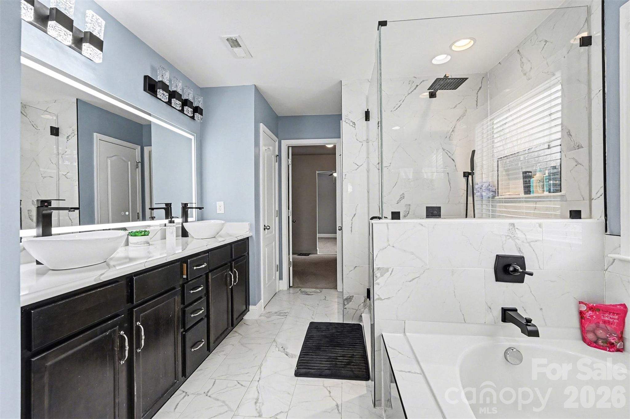 2213 Iron Works Drive Clover, SC 29710 - Photo 24 of 46 a spacious bathroom with a double vanity sink a mirror and a shower