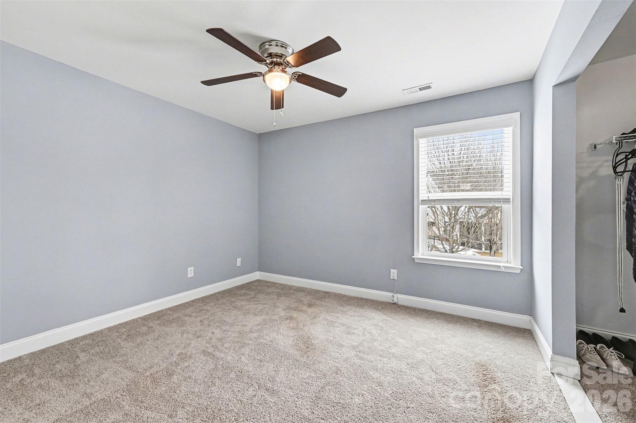 2213 Iron Works Drive Clover, SC 29710 - Photo 27 of 46 an empty room with a window and a fan