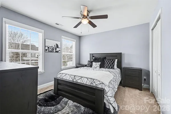 a bedroom with a large bed and a window