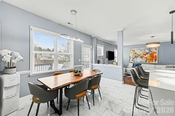 a kitchen with stainless steel appliances kitchen island granite countertop a sink a stove and a refrigerator