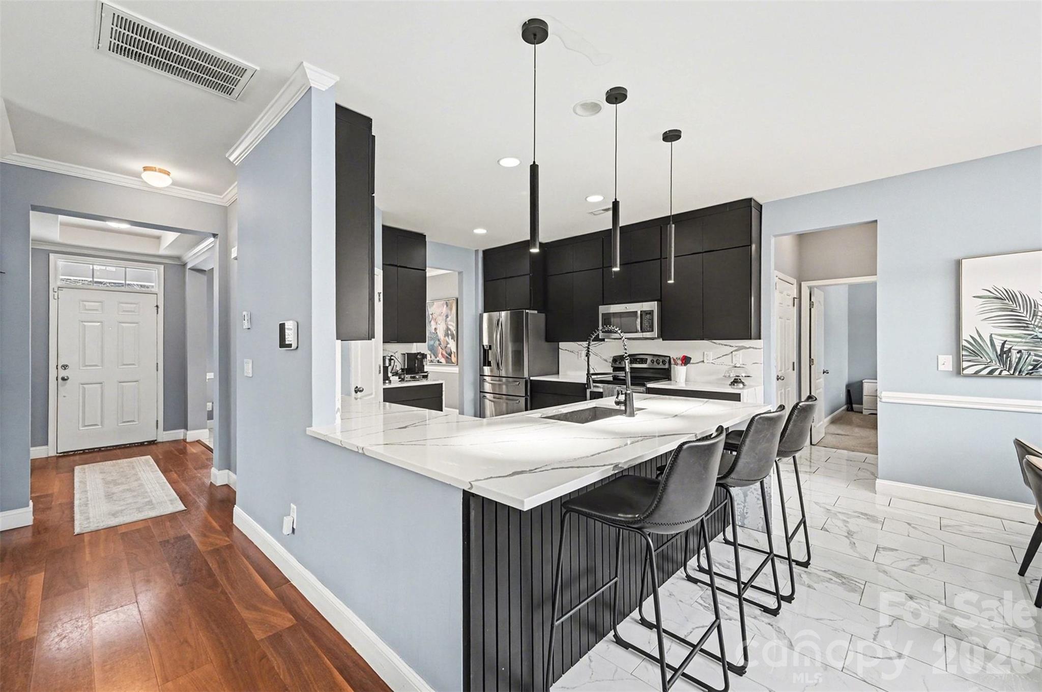 2213 Iron Works Drive Clover, SC 29710 - Photo 9 of 46 a kitchen with stainless steel appliances kitchen island granite countertop a sink a stove and a refrigerator