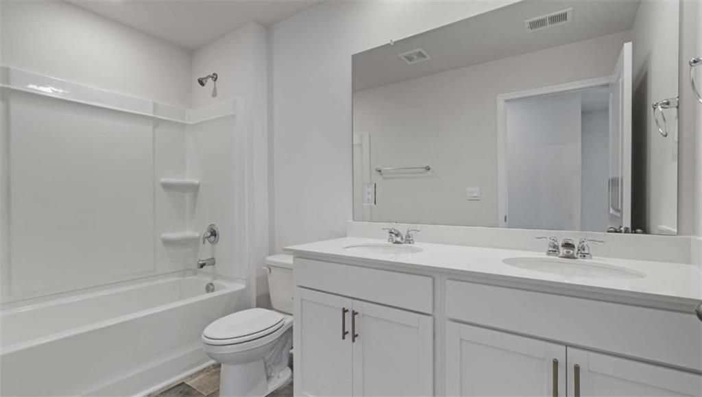 6062 Knickerbocker Street Mableton, GA 30126 - Photo 6 of 11 a bathroom with a sink toilet a mirror and shower