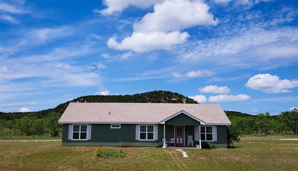 a aerial view of a house next to a yard with large tree