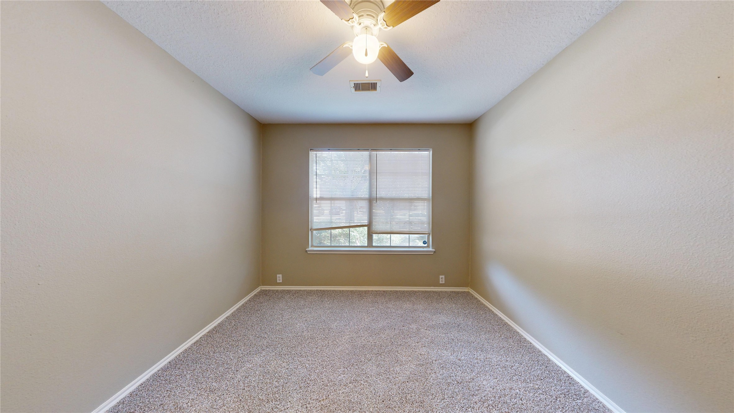 6007 Baldwin Elm Street Richmond, TX 77407 - Photo 39 of 45 an empty room with a window and a fan
