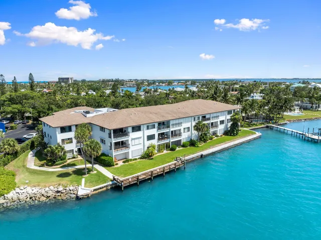 a aerial view of a house with swimming pool patio and outdoor seating